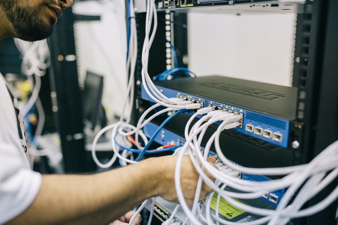 FlowlineBD engineer terminating and testing network cabling
